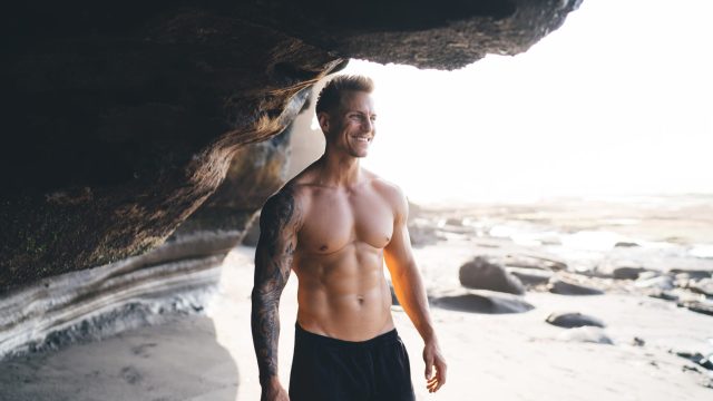 Happy,Young,Shirtless,Male,Model,In,Black,Shorts,With,Muscular